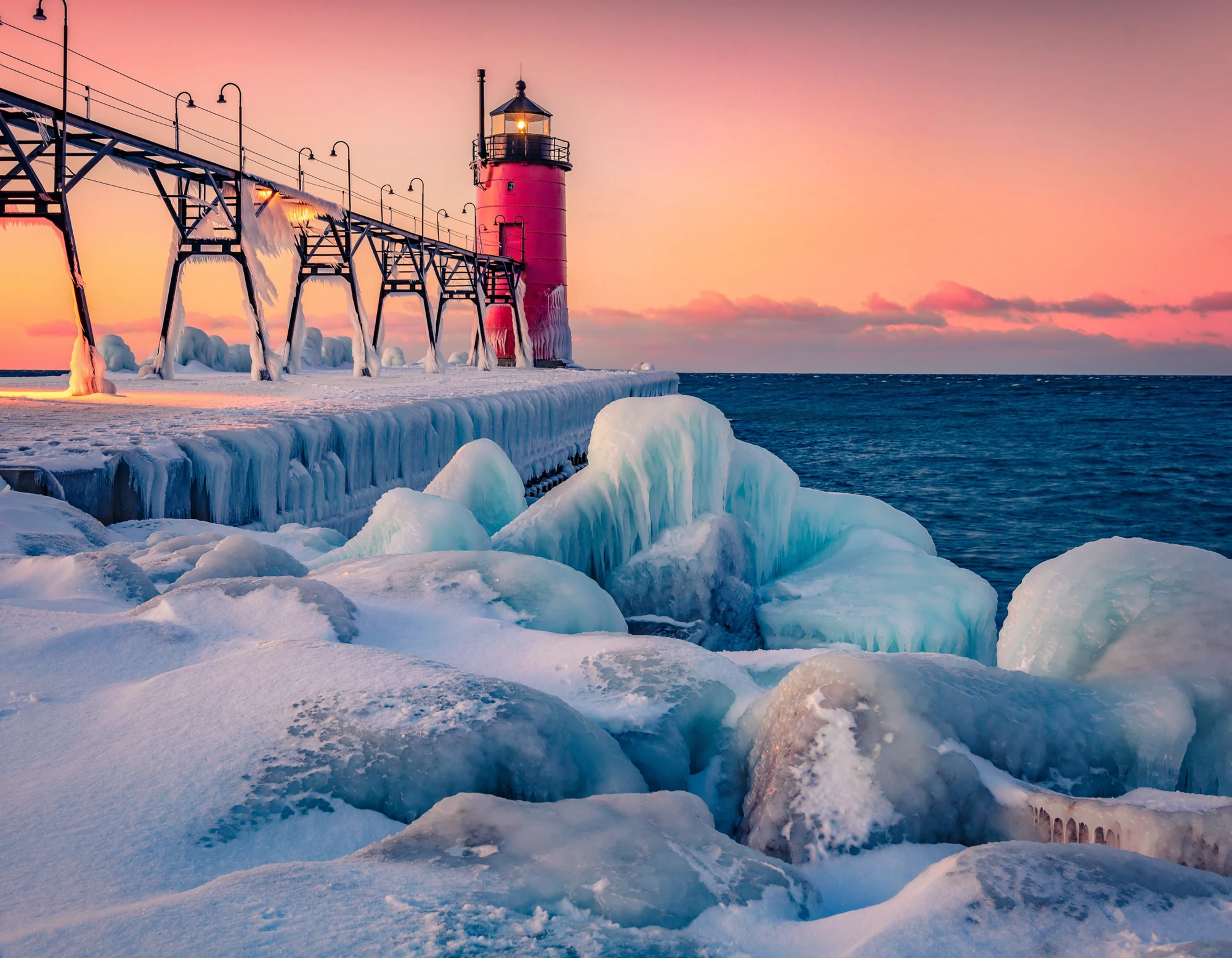 Michigan-inspired winter shoreline artwork with a lighthouse and sunset